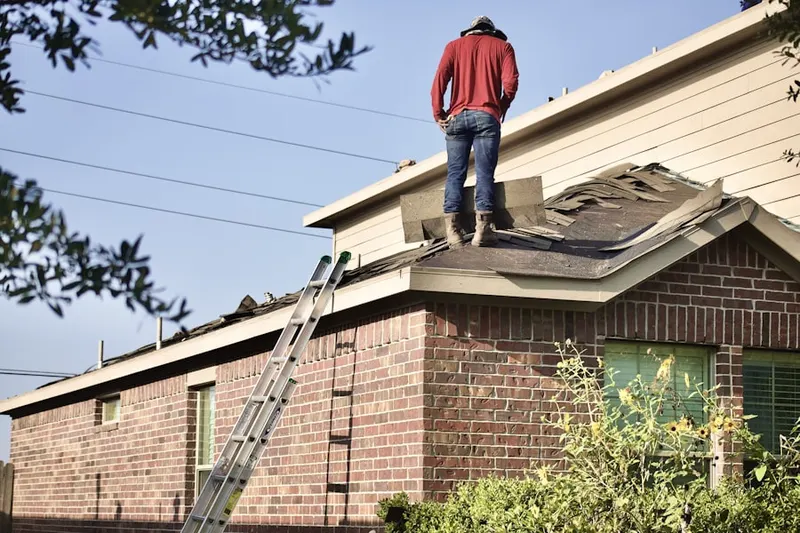 Professional roofer working on a residential roof in Elburn